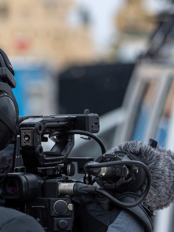 man-with-video-camera-reporter-cameraman-videographer-outdoor.jpg