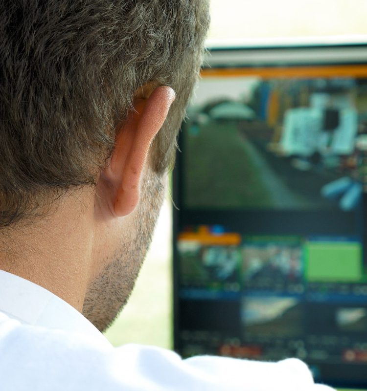 video-broadcast-editor-with-headphones-at-screen